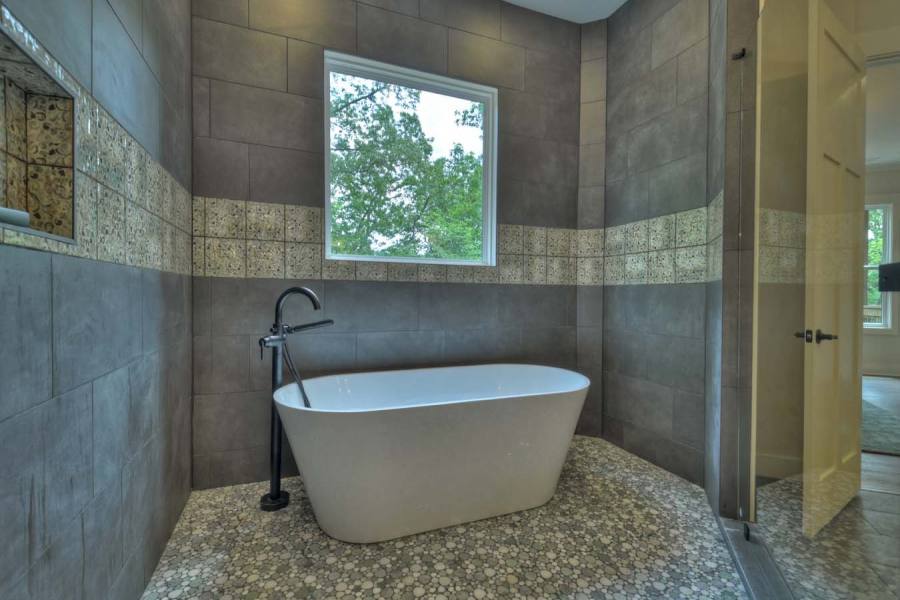 Master bath with tile shower and pebble floors - 2 shower heads and large bathtub