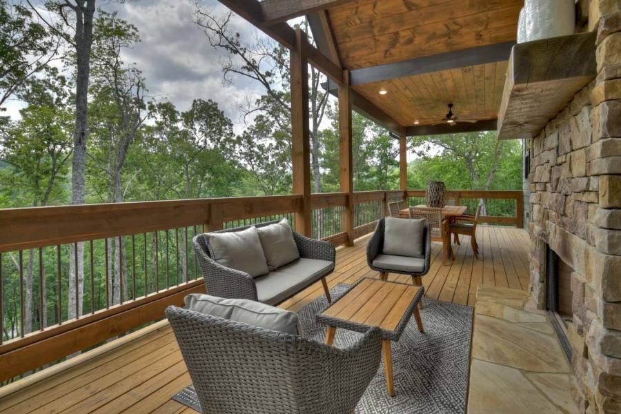 Large covered back deck off the main level with an outdoor rock wood burning fireplace with a gas starter and vaulted ceilings.