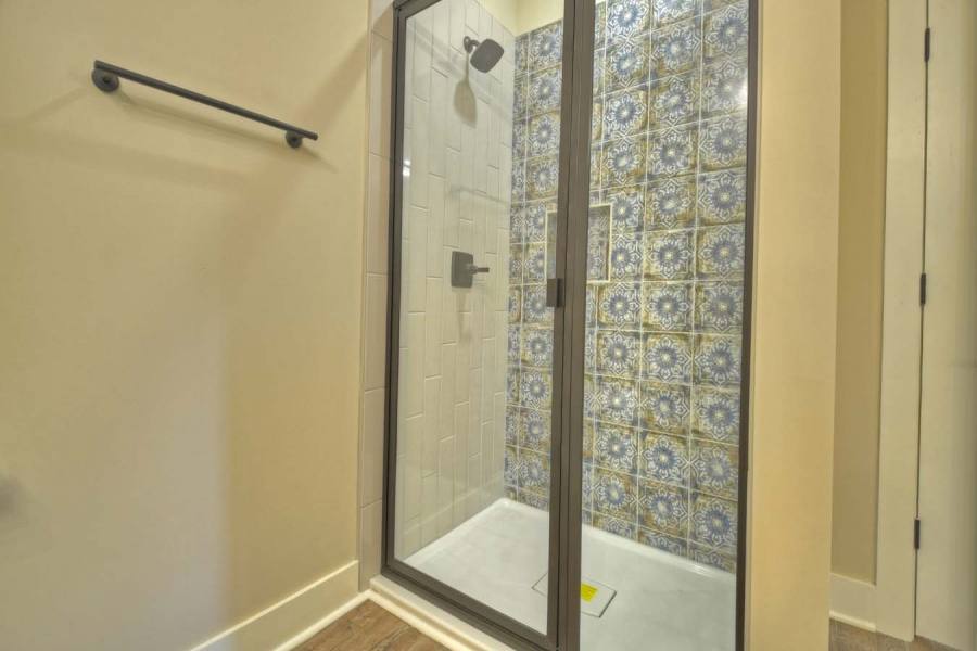 Terrace level showers with custom hand painted tile from Spain