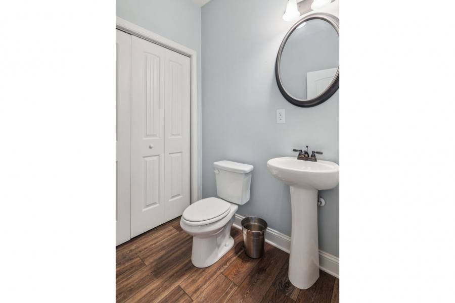 Guest half bath on main level with washer and dryer in large closet area.