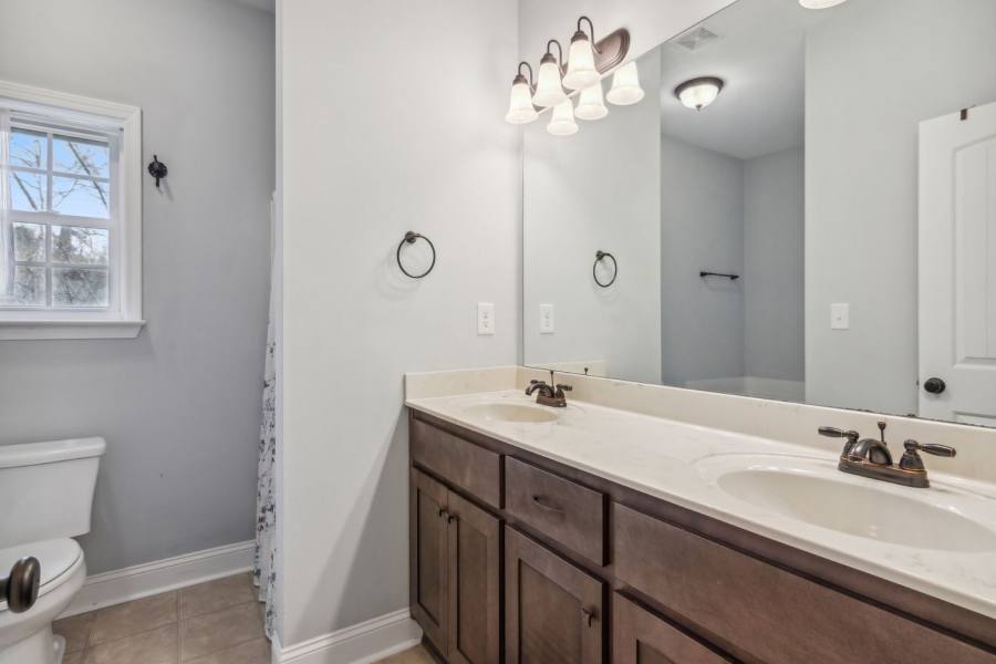 Master bath with double vanity and walk in closet, shower, and garden tub